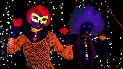 Poster - two female gogo ravers in fluorescent costume dancing in disco setting