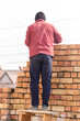 © schankz - Worker builds a brick wall in the house
