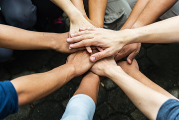 group of people united hands to built teamwork together with spirit - teamwork concepts.
