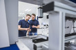 © Westend61 - Two men at a machine in testing instrument room