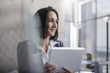 © Westend61 - Businesswoman holding digital tablet in office