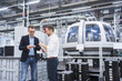 © Westend61 - Two men in factory shop floor examining product