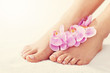 © Kalim - Soft female feet with french pedicure and flowers close up