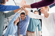 © LIGHTFIELD STUDIOS - business team giving highfive together on workplace in office, young professional group concept