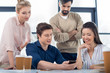 © LIGHTFIELD STUDIOS - group of young business people using smartphone on small business meeting