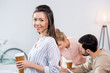 © LIGHTFIELD STUDIOS - portrait of smiling businesswoman holding coffee cup with colleagues near by