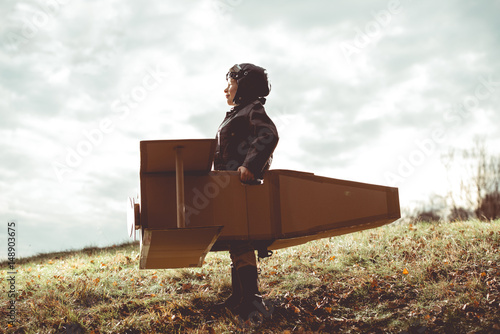 Cuadros en Lienzo front view vintage pilot boy flight by imagination on cardboard plane outdoor