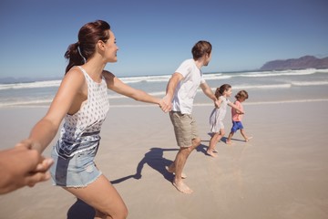 Wall Mural - Family holding hands at beach