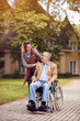 © luckybusiness - Medical: caregiver daughter with senior man in wheelchair.