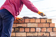 © schankz - Worker builds a brick wall in the house