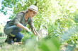 Blond woman with hat gardening