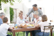 © goodluz - Family having breakfast together in holiday home