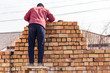 © schankz - Worker builds a brick wall in the house