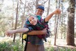 © wavebreak3 - Playful father carrying son in forest