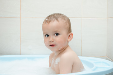 Wall Mural - Happy baby boy taking a bath