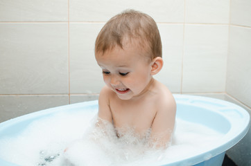 Wall Mural - Happy baby boy taking a bath