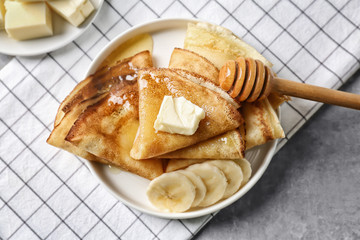 Wall Mural - Plate with delicious pancakes and banana on table