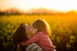 © Martinan - Little girl embracing her mom in the rapeseed field
