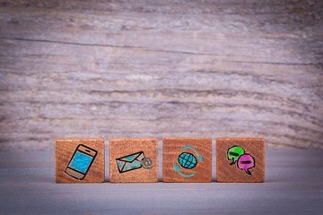Wall Mural - Contact Us, Customer Support Concept. Wooden objects at a dark textured background.