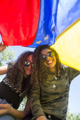 Wall Mural - Young girls with flag of Venezuela