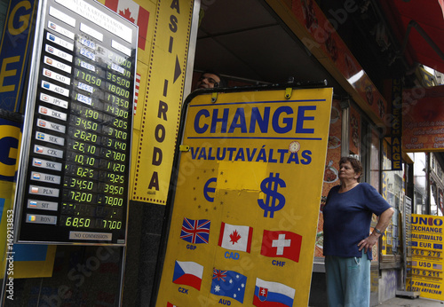 A Woman Checks The Exchange Rate In Front Of Currency A Woman Checks The Exchange Rate In Front Of Currency Budapest