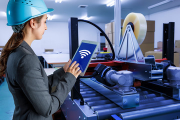 young woman using tablet PC in factory. industrial technology concept. factory automation. Industry4.0