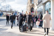 © moomusician - Blurred image of People walking on the street, with car, building in background. On Princes Street, the main shopping street in Edinburgh, United Kingdom.