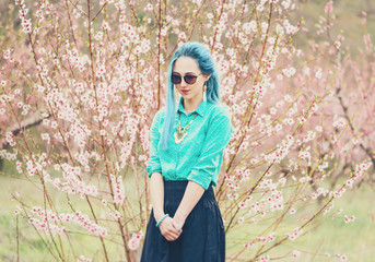 Wall Mural - Attractive woman walking in blossoming garden.