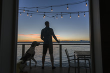 Man And Dog On Deck At Sunset