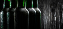 Green Bottles With Beer On Black Background