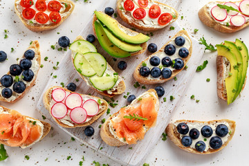 Wall Mural - Homemade summer toast with cream cheese Smoked Salmon, Blueberries, Radish, Cucumber, Avocado and cress salad. Fresh healthy concept food.