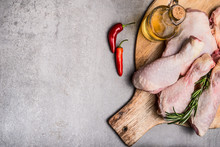 Raw Chicken Legs On Cutting Board For Cooking On Gray Concrete Background, Top View