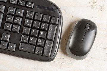 Closeup macro black pc keyboard with black wireless mouse