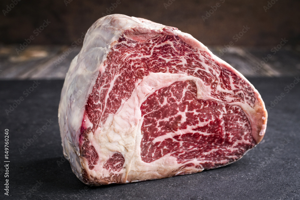 Raw dry aged Black Angus Entrecote Steak as close-up on a slate - obrazy, fototapety, plakaty 