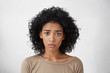 © wayhome.studio  - Headshot of regretful young mixed race woman feeling sorry for doing something wrong, looking at camera with brows frowned, doing her best to get forgiveness from her boyfriend during quarrel