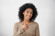 © wayhome.studio  - That's way all better. Cheerful enthusiastic beautiful young mixed race woman with curly hair showing thumbs up gesture to camera, expression her like and approval of idea or project, smiling broadly
