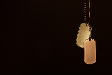 Military ID tags on a dark background