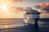 Luxury cruise ship leaving port at sunset