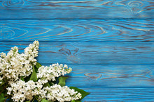 Lilac Flowers On Blue Wooden Vintage Background.