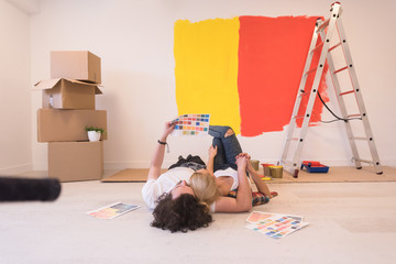 Wall Mural - Happy young couple relaxing after painting