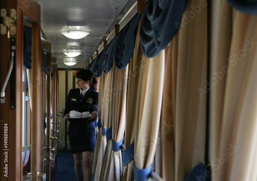 An Attendant Serves Tea In The Golden Eagle Luxury Train