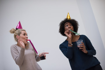 Poster - smiling women in party caps blowing to whistles