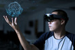 © Olly - Trying Virtual Reality with hololens glasses.  Business man try virtual reality glasses in the dark room with advanced technology. Future technology concept.