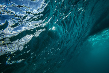 Wall Mural - ocean wave underwater view to rippled surface