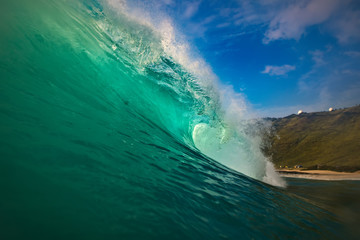 Wall Mural - hawaiian huge shorebreak wave. ocean water for watersport activity. surfing lessons at sunset time. 