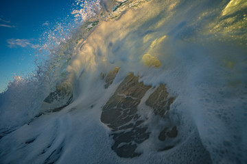Wall Mural - ocean rough wave closing and crashing against sandy beach. tropical background for surfing postcards