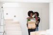 © .shock - multiethnic couple moving into a new home