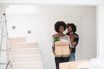 Wall Mural - multiethnic couple moving into a new home