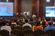 © THANANIT - Abstract blurred photo of conference hall or seminar room with attendee background