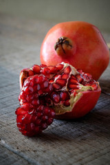 Wall Mural - Ripe pomegranate fruit on wooden vintage background.